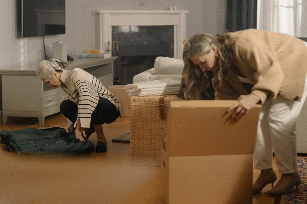 An elderly person packing boxes for moving out. 