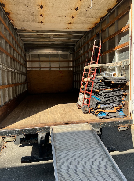 The back of a large truck with equipment. 