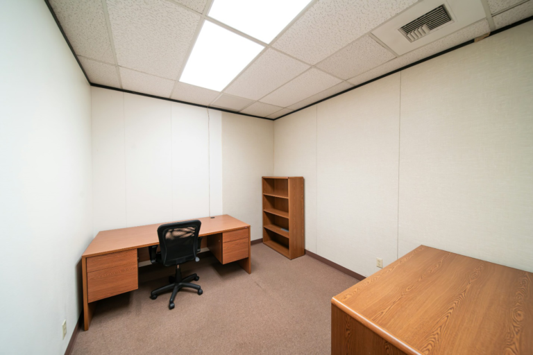 A small office space with wooden furniture.